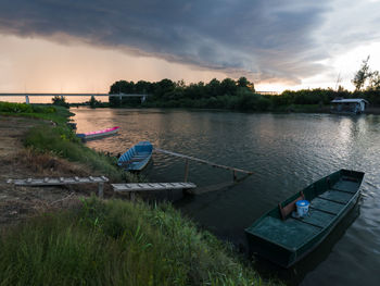 Scenic view of river against sky at sunset