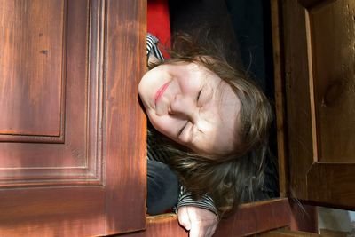 Close-up of girl with open door