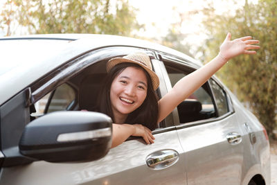Portrait of a smiling young woman in car
