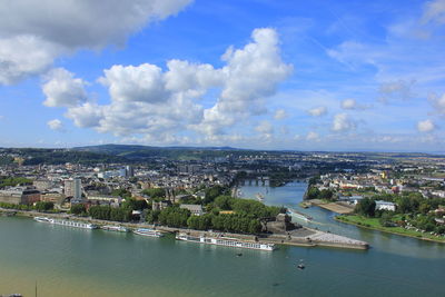 High angle view of townscape by sea against sky