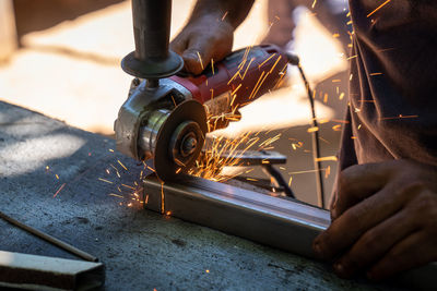 Close-up of hands working in factory