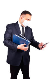 Young man using smart phone against white background