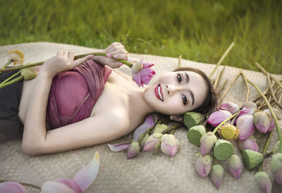 Portrait of woman lying down on bed