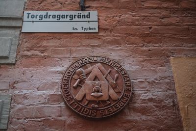 Close-up of text on brick wall