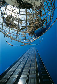 Low angle view of skyscraper against clear blue sky