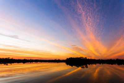 Scenic view of lake against romantic sky at sunset