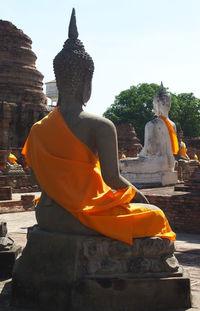 Statue of buddha against temple