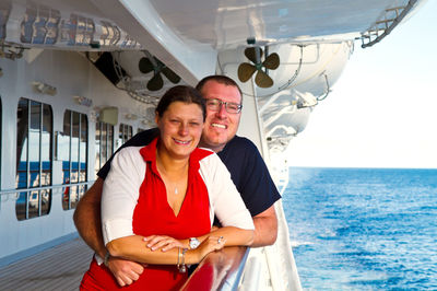 Portrait of smiling mature couple in ship on sea