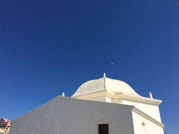 Low angle view of temple against clear blue sky