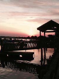 Pier on sea at sunset