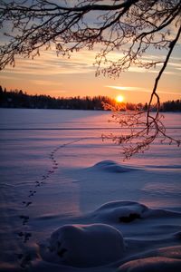 Scenic view of frozen lake against sky during sunrise