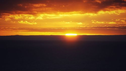 Scenic view of sea against orange sky during sunset