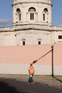 Rear view of man standing outside building