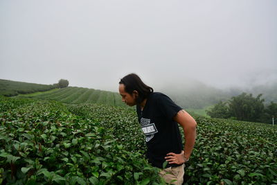 Man standing on field against sky