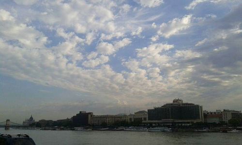 Boats in river with city in background