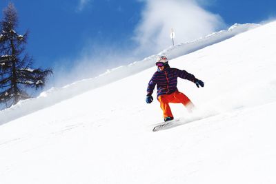 Man snowboarding on mountain slope