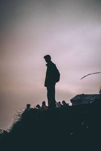 Silhouette man standing against sky during sunset