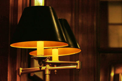 Close-up of illuminated lamp on table at home
