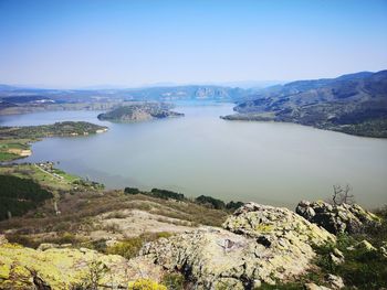 High angle view of lake and mountains against sky