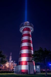 Low angle view of illuminated building against sky at night