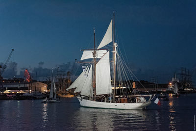 Boats on harbor at dusk