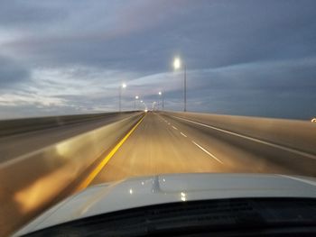 Cropped image of car on road against sky