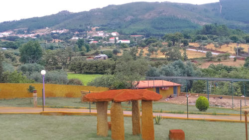 High angle view of trees and buildings against mountains