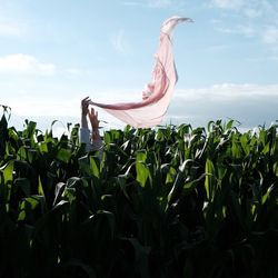 Woman standing on field against sky