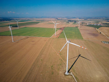 Aerial view of wind turbine in countryside area, wind power plants in agricultural field