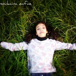 Portrait of cute girl on grassy field