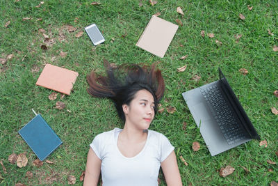 High angle view of woman using phone on field