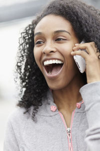 Laughing woman talking via cell phone