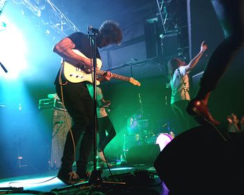 Woman enjoying music concert at night
