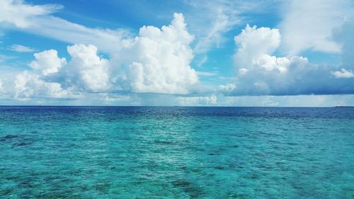 Scenic view of sea against cloudy sky