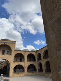 Low angle view of old building against cloudy sky