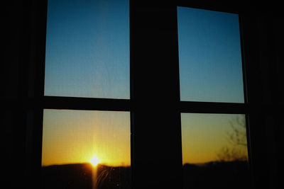 Sunset seen through glass window