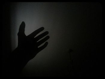 Silhouette people in dark room