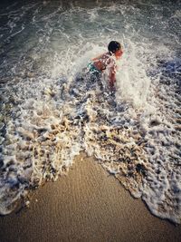 High angle view of man splashing water in sea