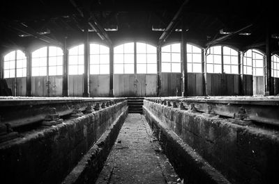 Bright light shining through windows of abandoned factory