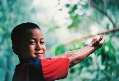 Portrait of happy boy looking away outdoors