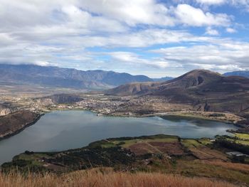 Scenic view of lake against cloudy sky