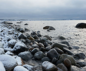 Rocks on beach against sky