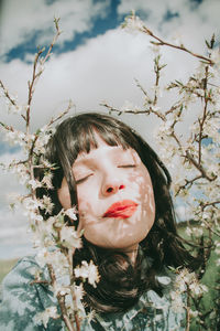 Portrait of girl with plants against trees