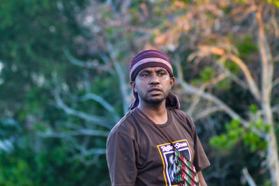 Portrait of young man standing outdoors