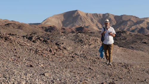 Senior man walking in the desert 