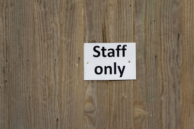 Close-up of text on wooden wall