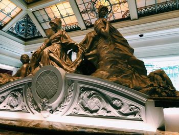 Low angle view of statue against building
