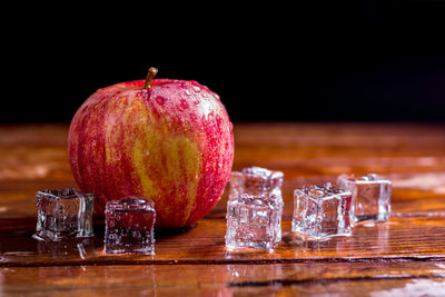 Close-up of fruits on table against black background