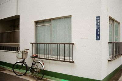 Bicycle parked by the window on corner