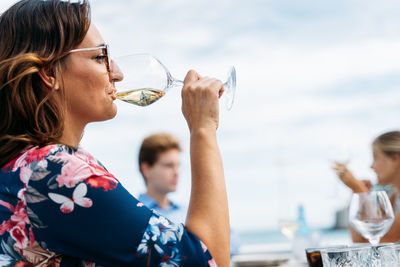 Portrait of woman drinking water from glass